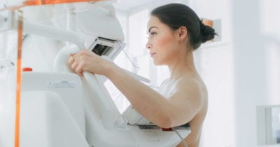 Woman getting her breast scanned in a Mammography machine